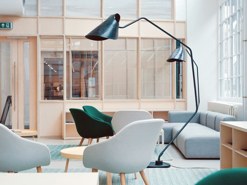 Lounge seating and an arc floor lamp in a light-filled workspace
